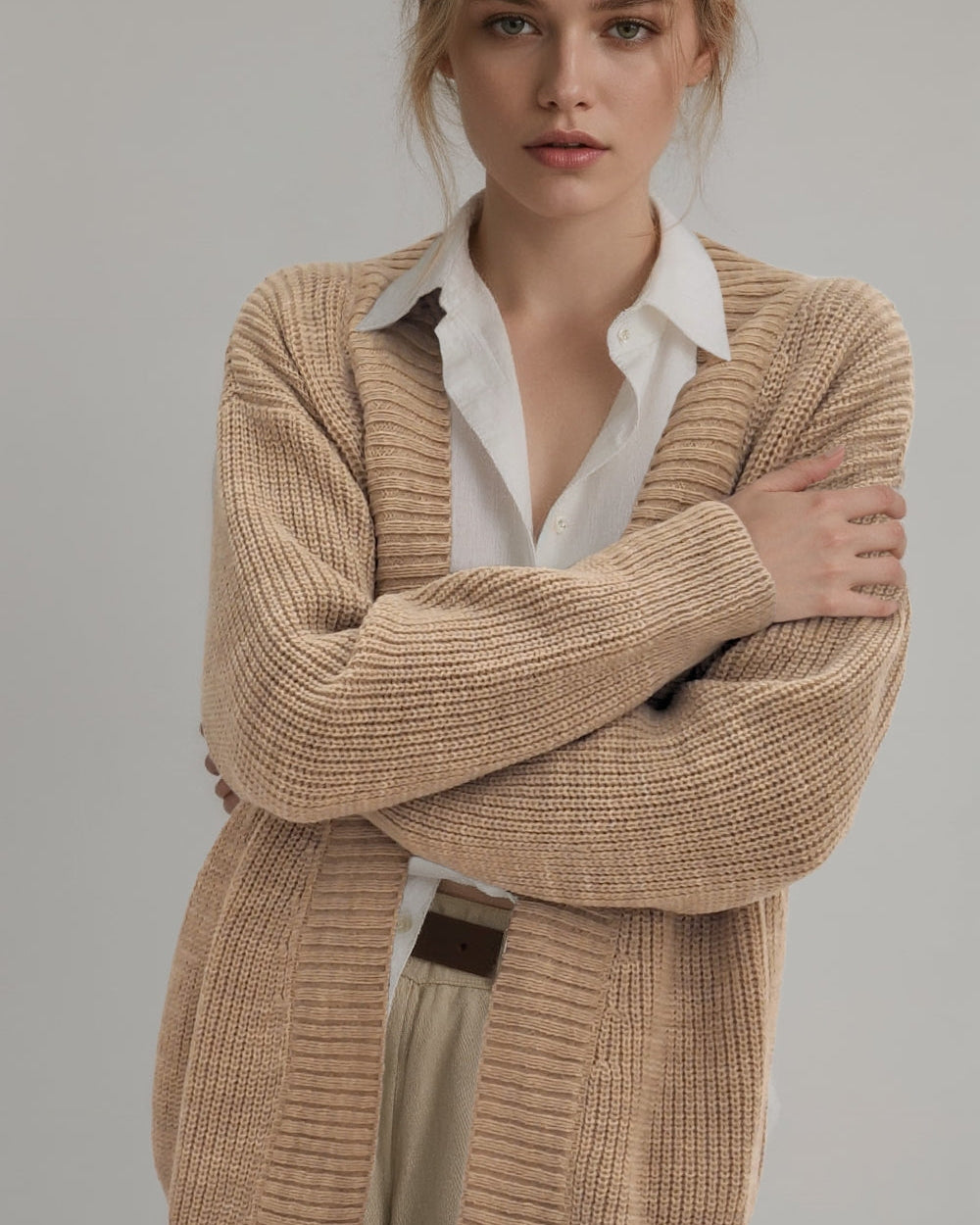 Front view showing the sleeve details of the Brio Beige knit sweater.